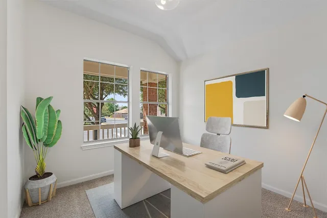 a living room with furniture and a potted plant