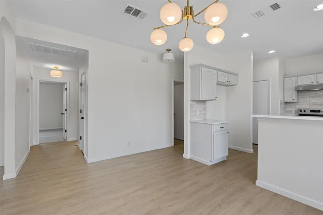 a view of a kitchen with a sink and a refrigerator
