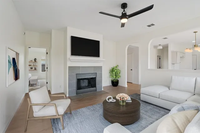 a living room with furniture fireplace and a flat screen tv