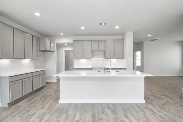 a view of a kitchen with kitchen island stainless steel appliances wooden floor and window