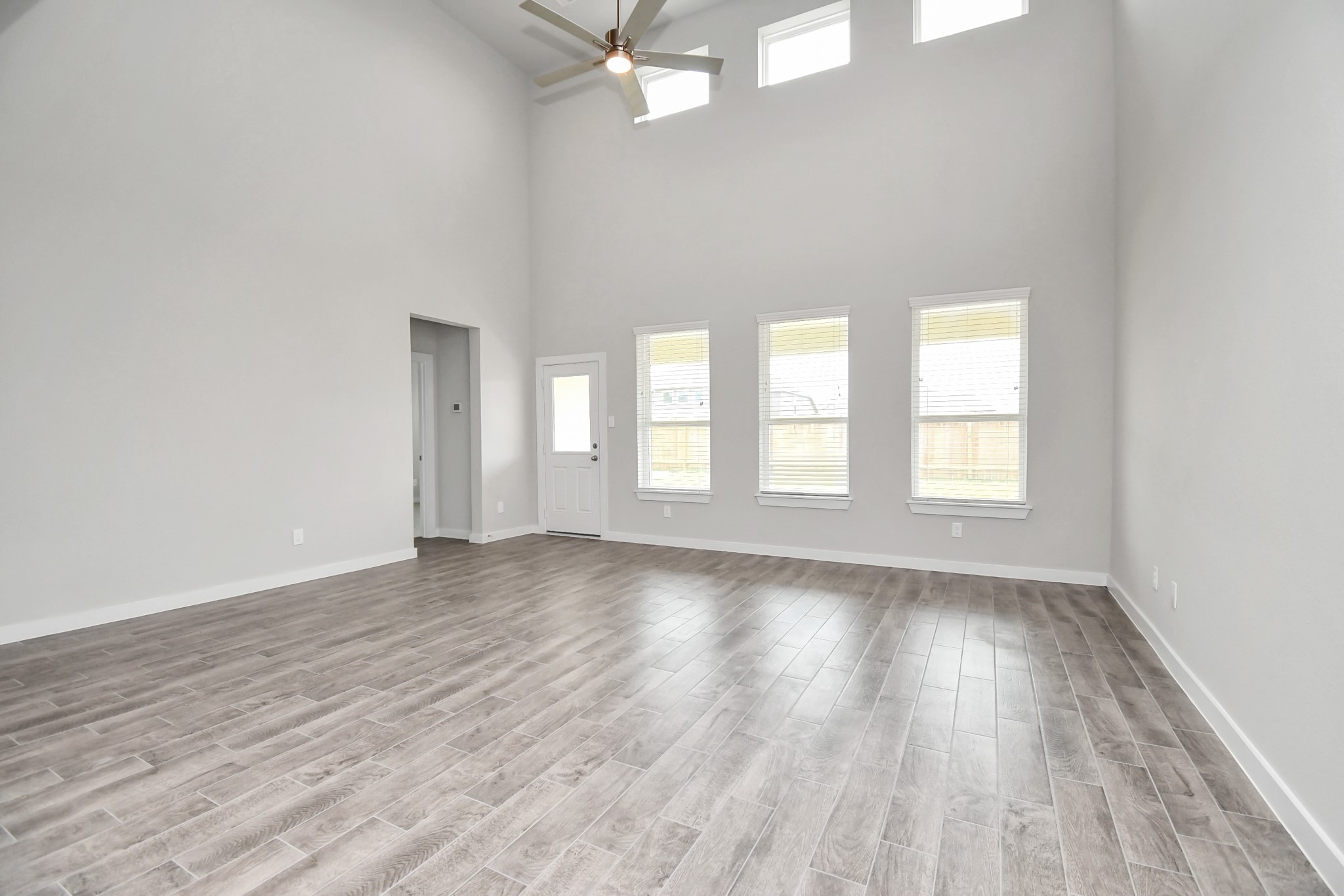 15806 Telge Ridge Lane Cypress, TX 77429 - Photo 18 of 40 an empty room with wooden floor and windows
