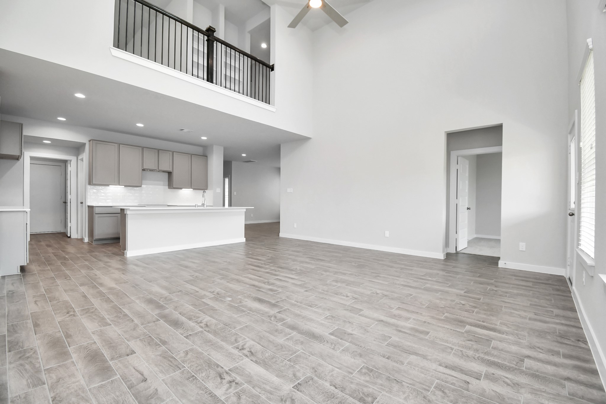 15806 Telge Ridge Lane Cypress, TX 77429 - Photo 19 of 40 a view of a kitchen with kitchen island stainless steel appliances wooden floor and view living room