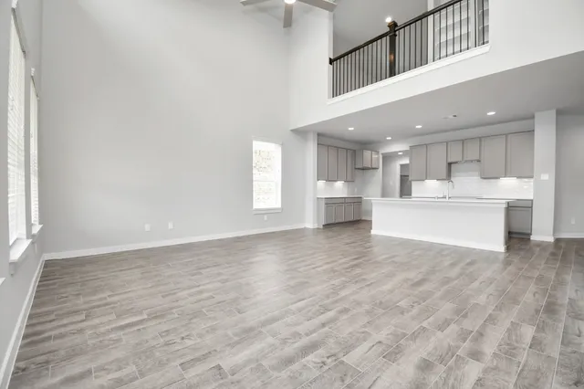 a spacious bathroom with a double vanity sink a mirror and a bathtub