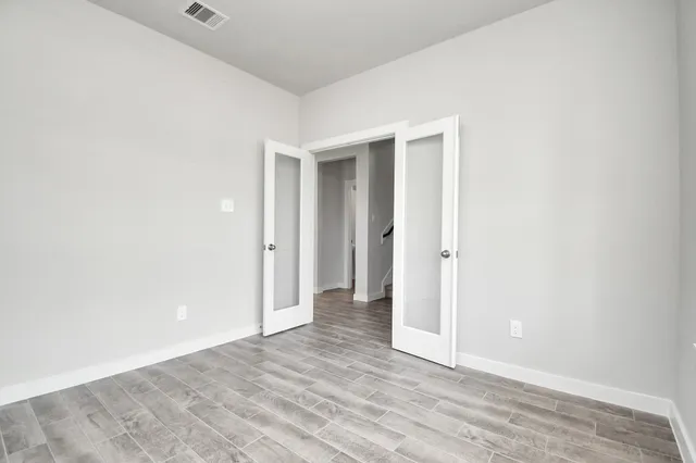 a kitchen with a sink cabinets and wooden floor