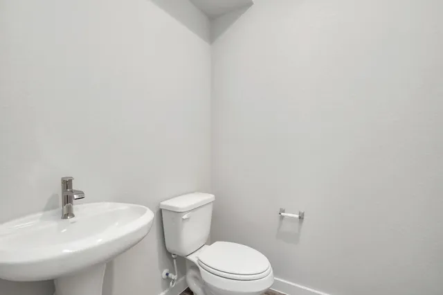 a large kitchen with stainless steel appliances a large counter top a stove and a refrigerator