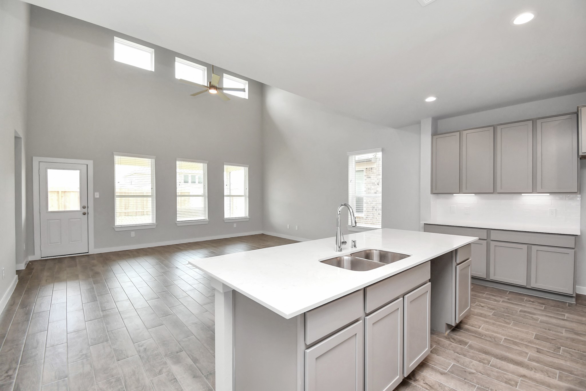 15806 Telge Ridge Lane Cypress, TX 77429 - Photo 13 of 40 a kitchen with a sink cabinets and wooden floor
