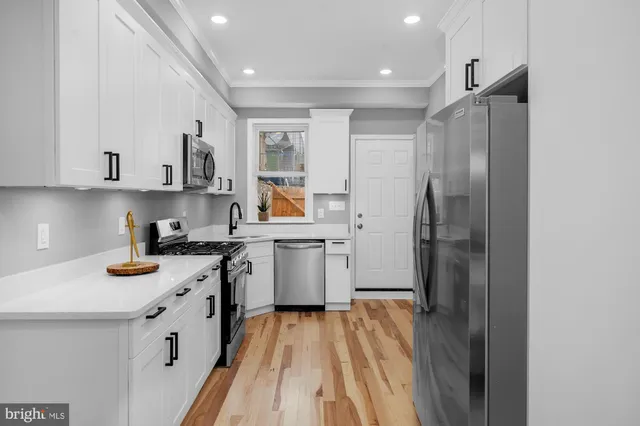 a kitchen with a white cabinets and refrigerator