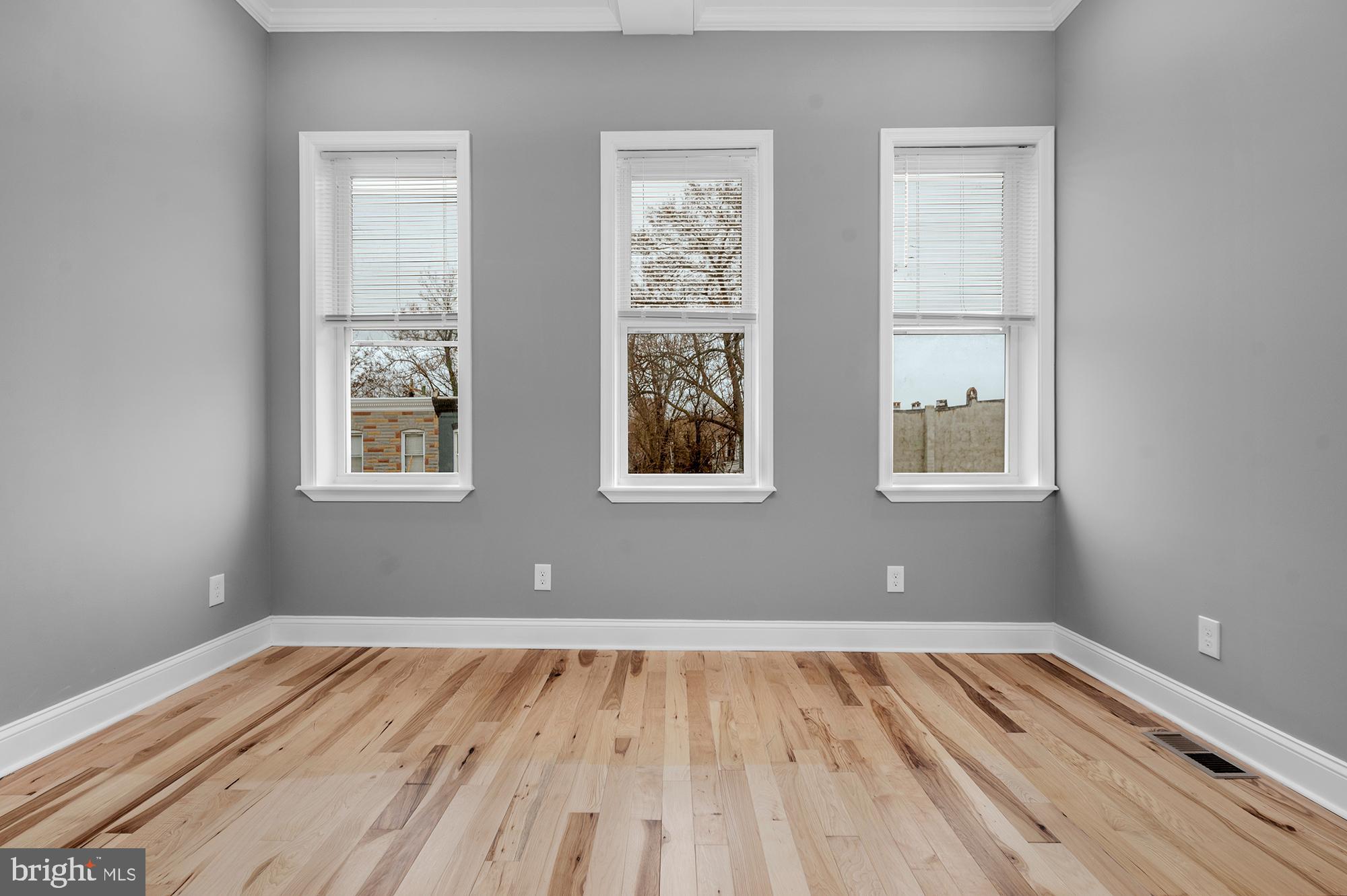 1908 East Lanvale Street Baltimore, MD 21213 - Photo 19 of 49 a view of empty room with wooden floor and fan