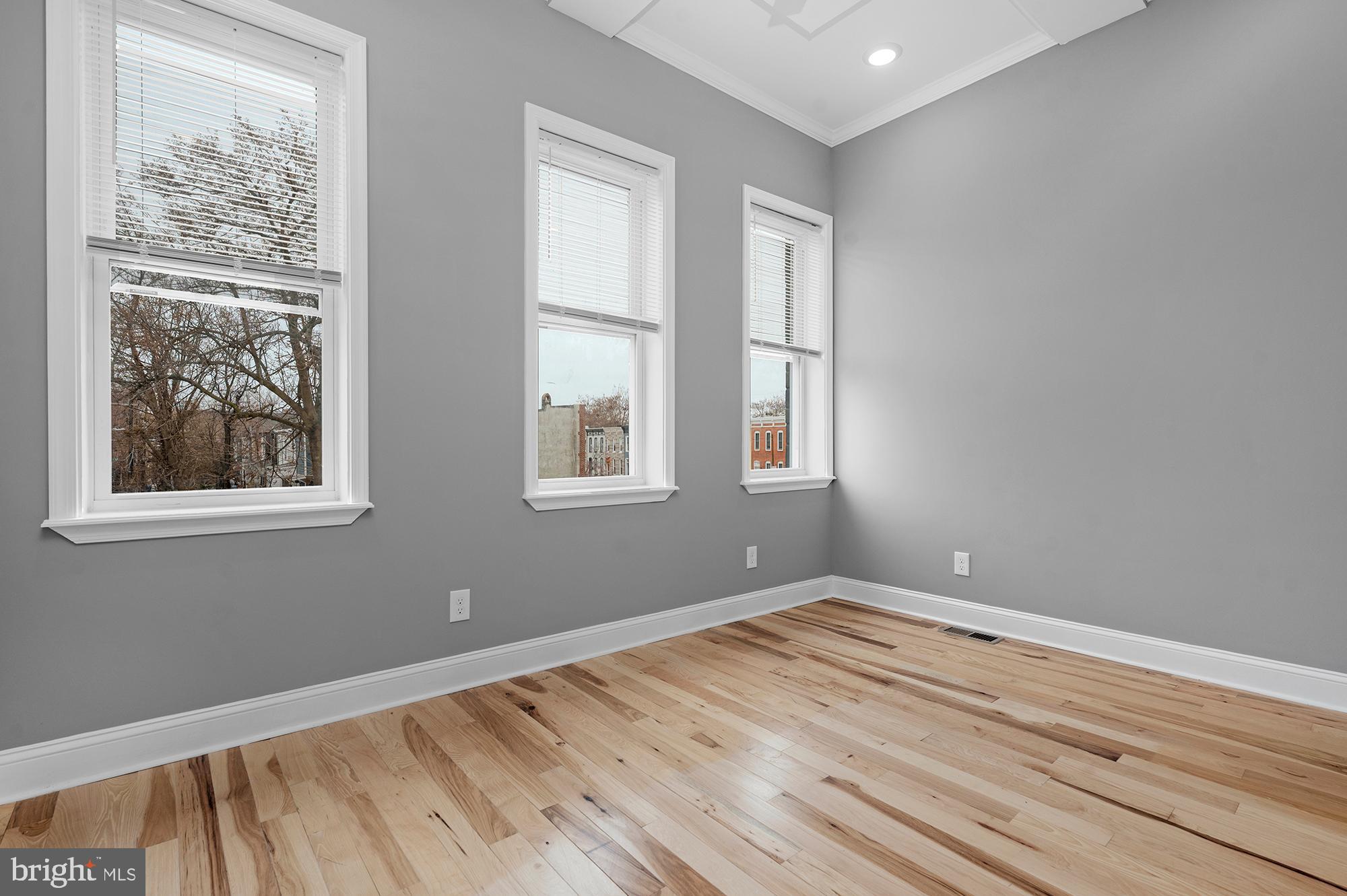 1908 East Lanvale Street Baltimore, MD 21213 - Photo 20 of 49 a view of empty room with wooden floor and fan