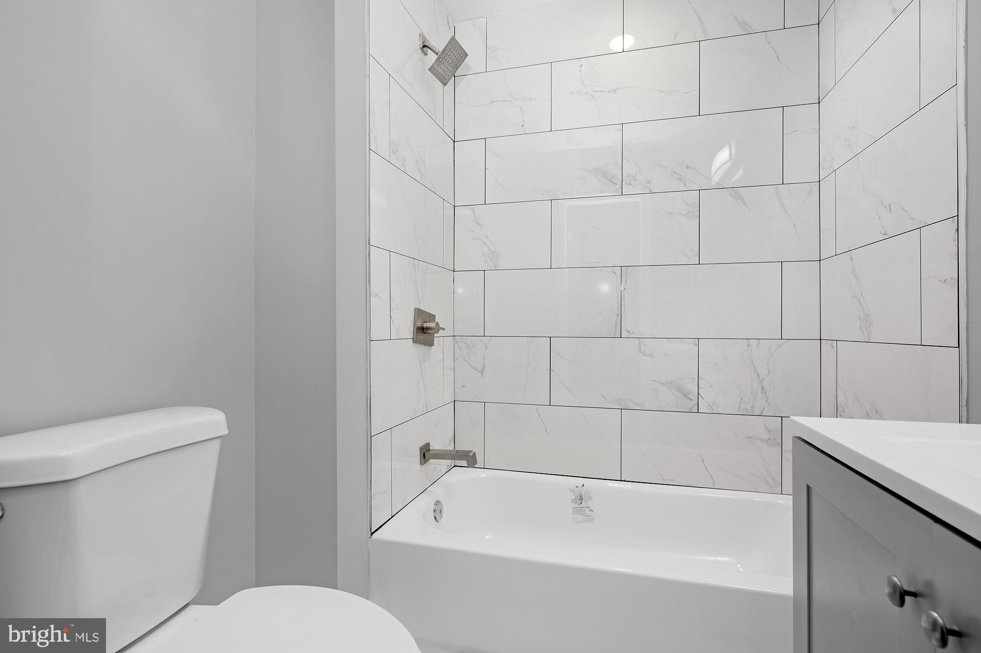 1908 East Lanvale Street Baltimore, MD 21213 - Photo 29 of 49 a white bath tub sitting next to a toilet