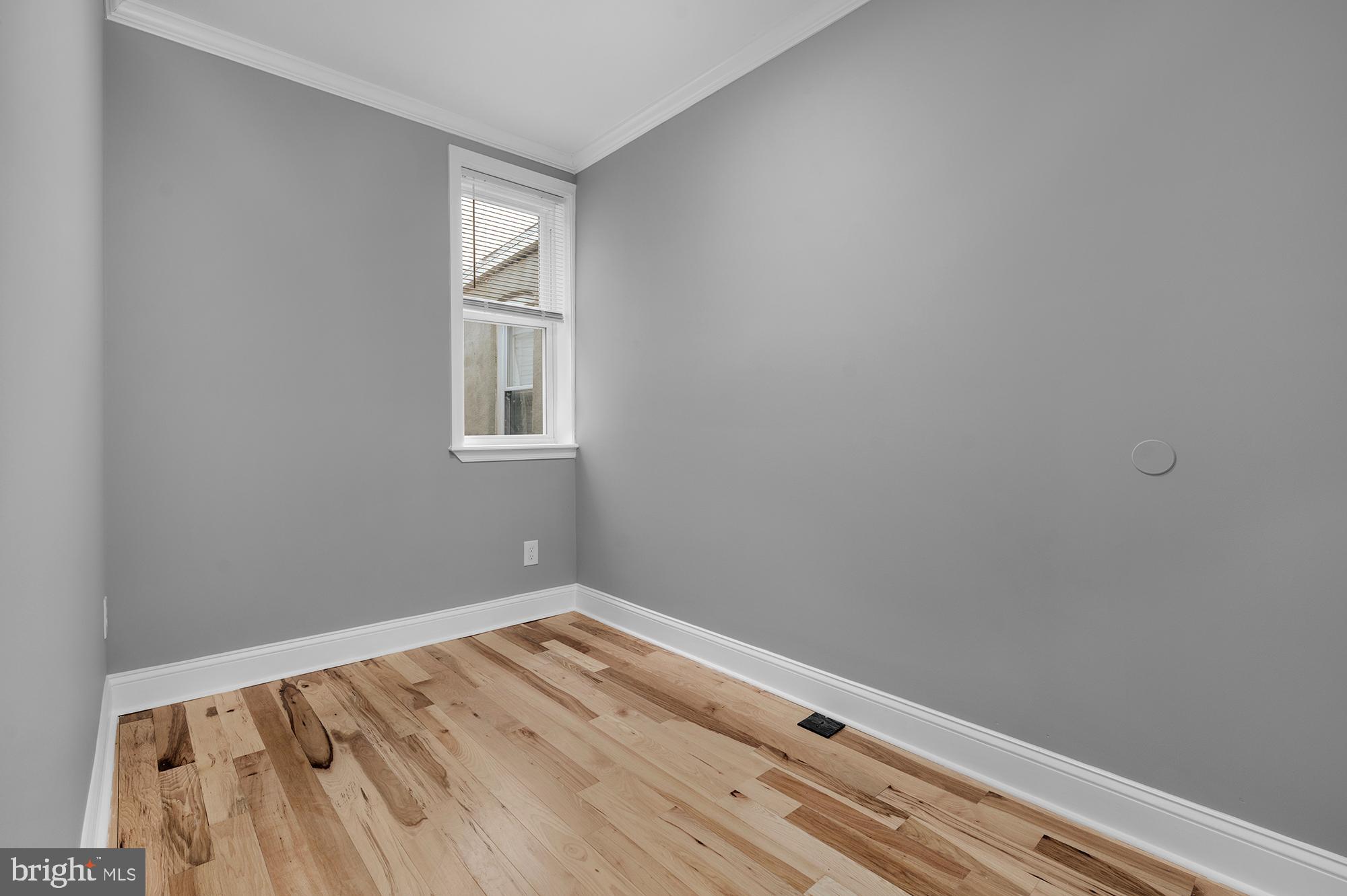 1908 East Lanvale Street Baltimore, MD 21213 - Photo 33 of 49 a view of an empty room with wooden floor and a window