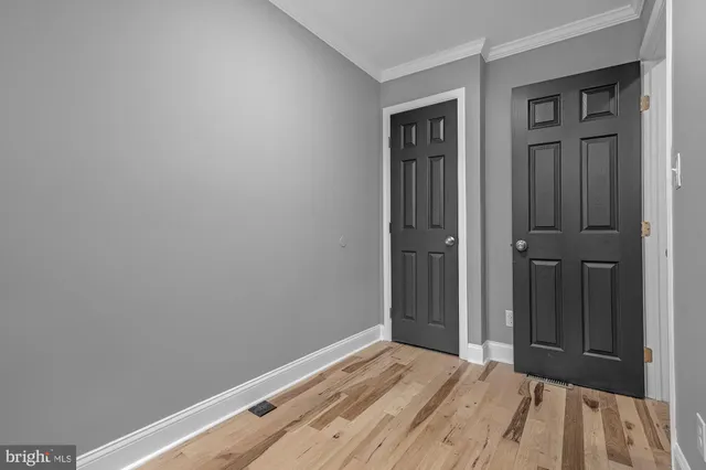 a view of a room with wooden floor