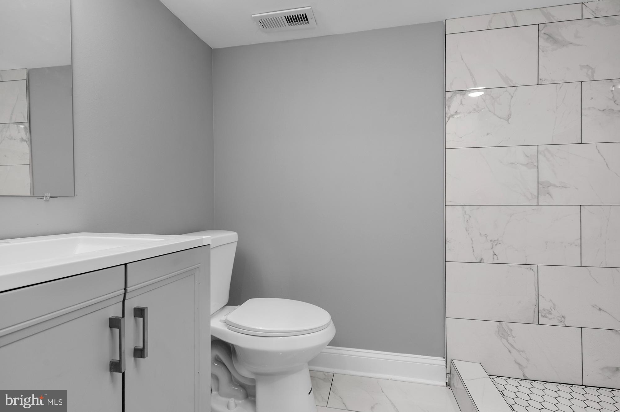 1908 East Lanvale Street Baltimore, MD 21213 - Photo 38 of 49 a white toilet sitting next to a bathroom sink