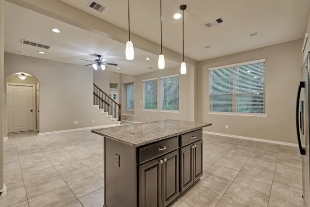 a kitchen that has a lot of cabinets and wooden floor