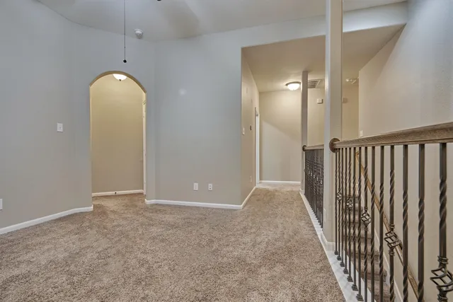 an empty room with wooden floor and mirror