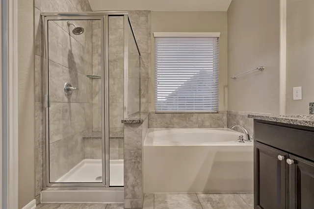a bathroom with a bathtub and a shower