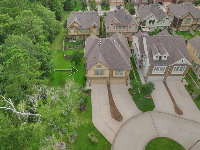 an aerial view of a house with garden space and street view