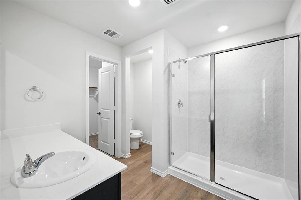 405 Regiment Road Sherman, TX 75090 - Photo 14 of 22 a bathroom with a tub shower a sink and mirror