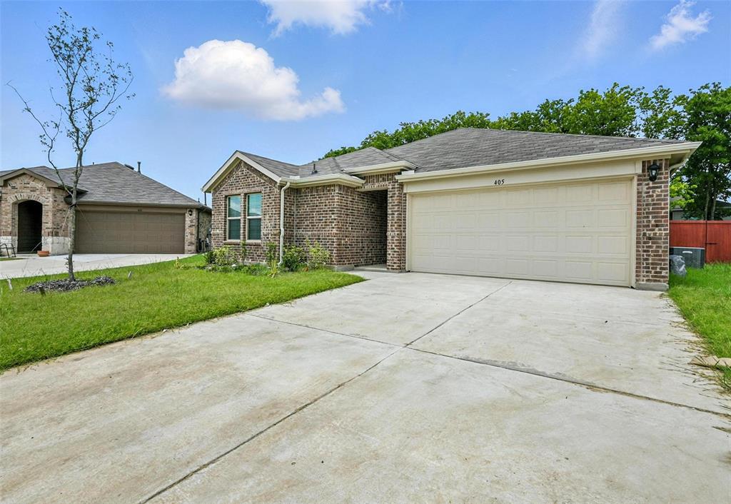 405 Regiment Road Sherman, TX 75090 - Photo 18 of 22 a front view of a house with a yard and garage