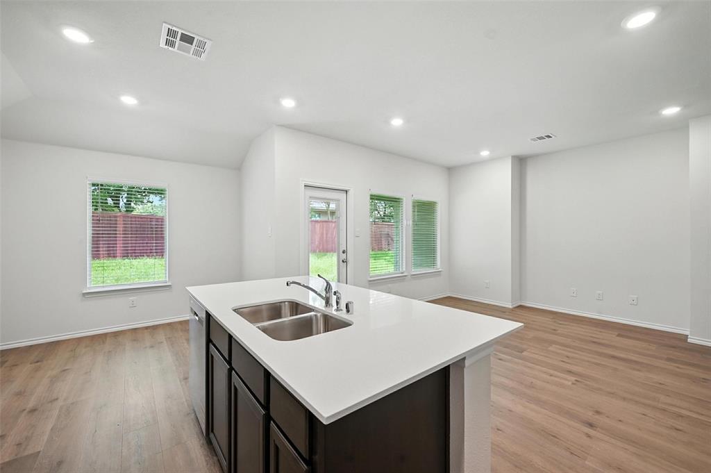 405 Regiment Road Sherman, TX 75090 - Photo 21 of 22 a kitchen with a sink cabinets and wooden floor