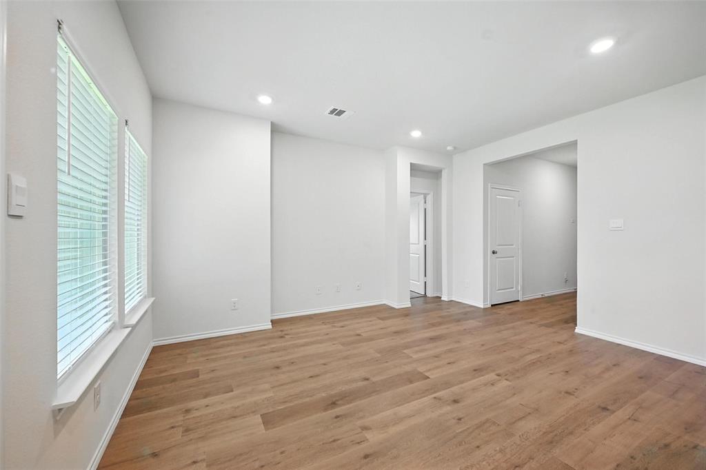 405 Regiment Road Sherman, TX 75090 - Photo 7 of 22 a view of an empty room with wooden floor and a window