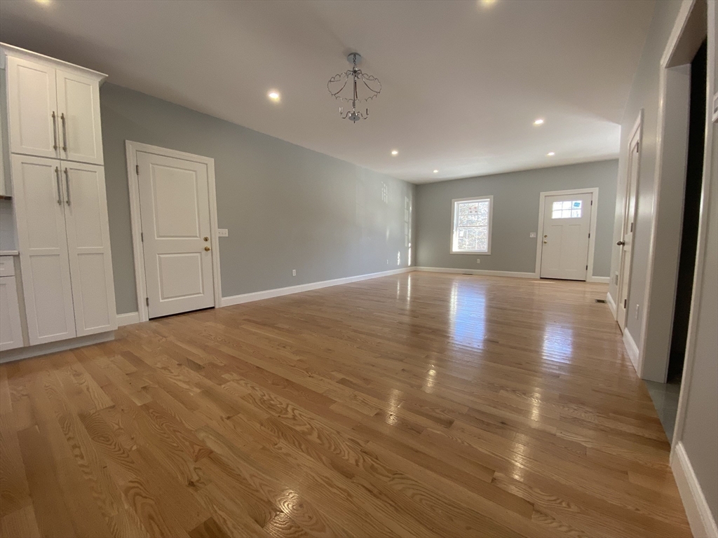 855 County Street, Unit 2 Attleboro, MA 02703 - Photo 7 of 27 a view of empty room with wooden floor and fan