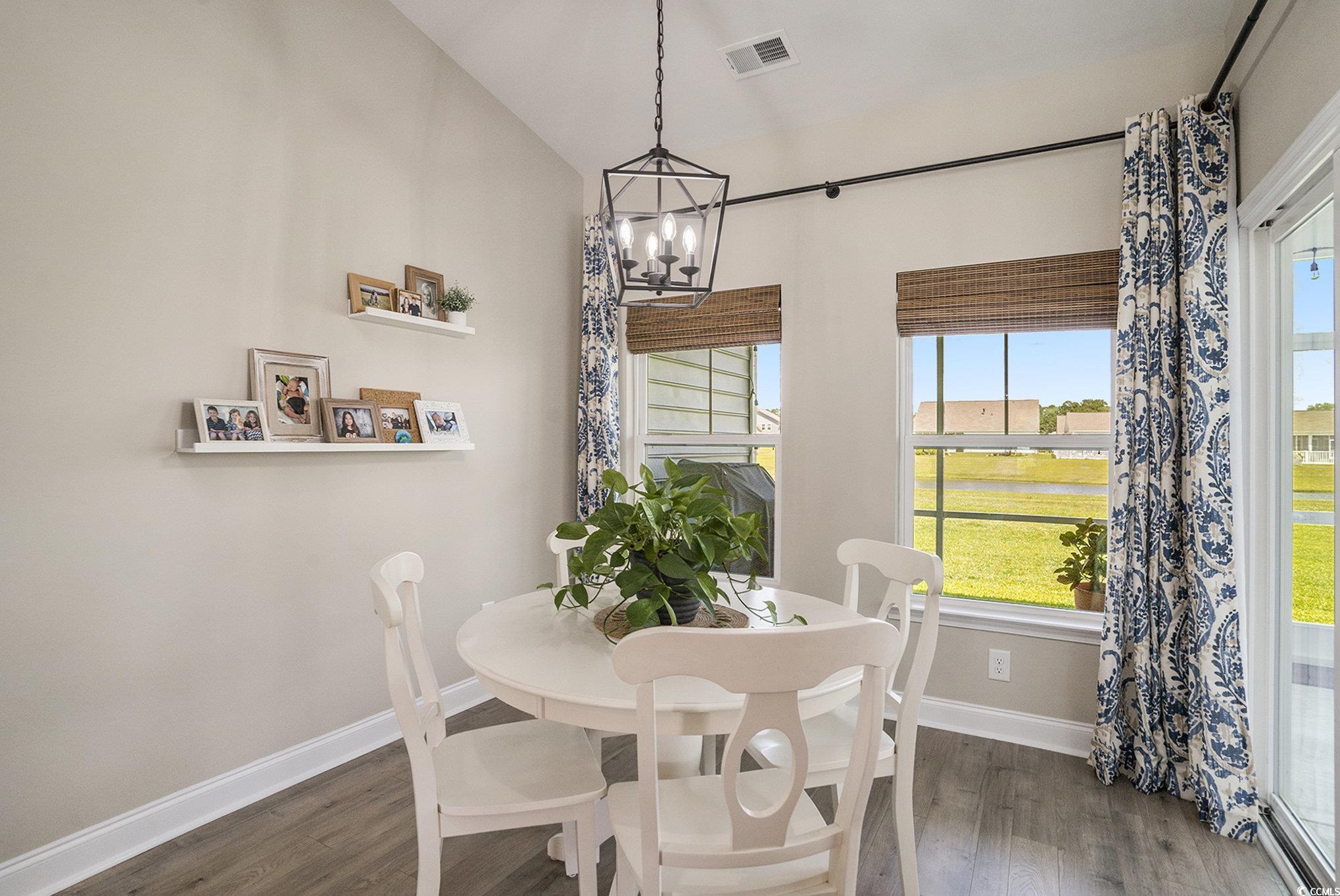 860 Brant Street Myrtle Beach, SC 29579 - Photo 17 of 40 Dining area with a chandelier and dark wood-style