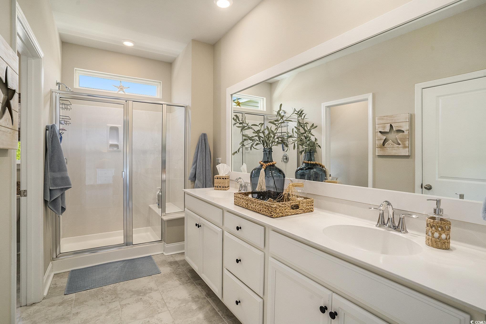 860 Brant Street Myrtle Beach, SC 29579 - Photo 22 of 40 Bathroom with double vanity, a stall shower, and r