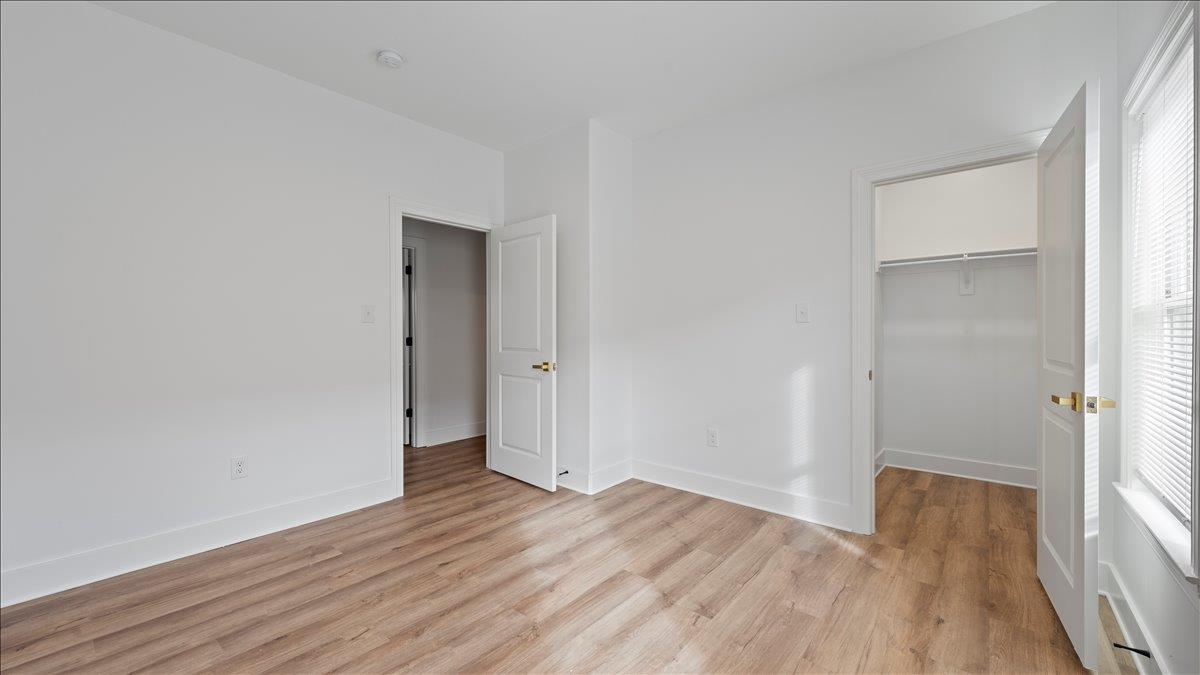 1072 Bruce Street Memphis, TN 38104 - Photo 16 of 27 a view of an empty room with wooden floor and a window
