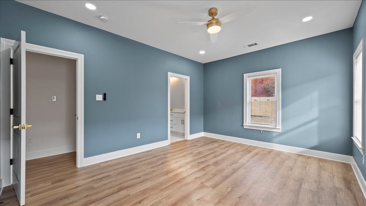 1072 Bruce Street Memphis, TN 38104 - Photo 20 of 27 a view of an empty room with wooden floor and a window