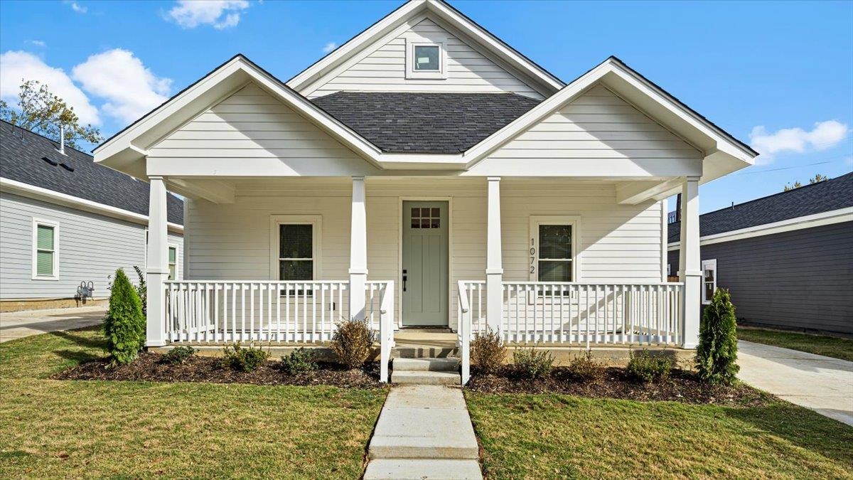 1072 Bruce Street Memphis, TN 38104 - Photo 2 of 27 a front view of a house with a yard