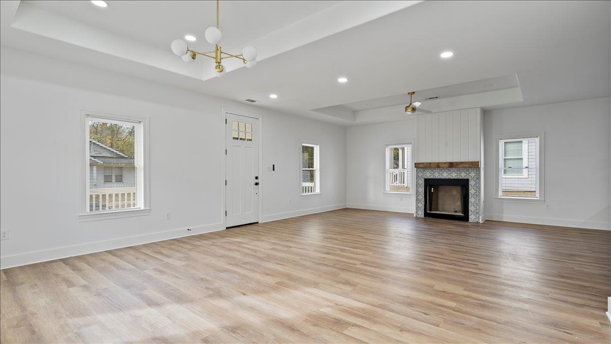 1072 Bruce Street Memphis, TN 38104 - Photo 8 of 27 an empty room with wooden floor fireplace and windows