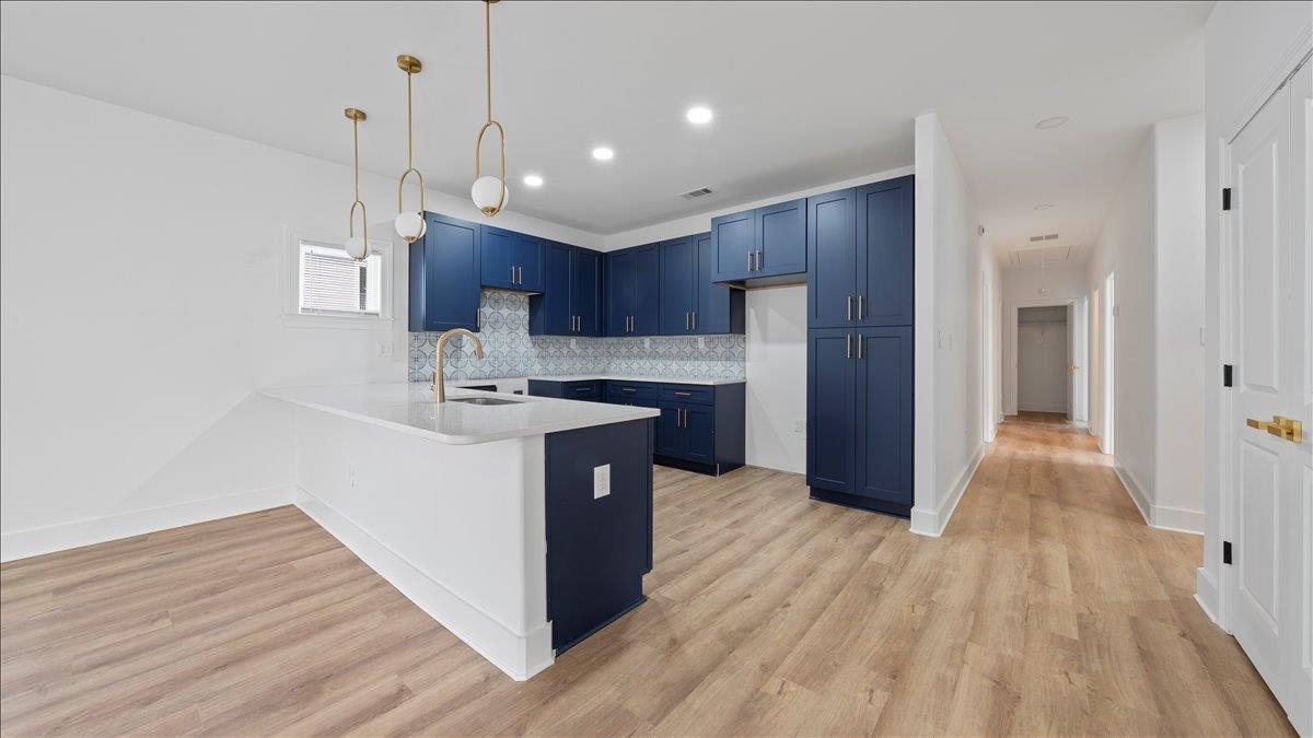 1072 Bruce Street Memphis, TN 38104 - Photo 9 of 27 a kitchen with kitchen island wooden floors appliances and cabinets