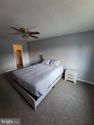 a bedroom with a bed and lamp