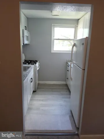 a bathroom with a sink toilet and window