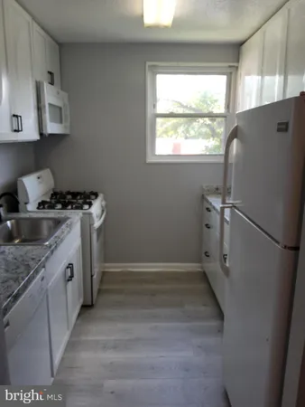 a kitchen with a stove a refrigerator and a sink