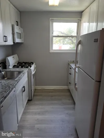 a kitchen with a stove a refrigerator and a sink