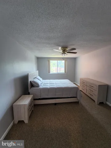 a spacious bedroom with a bed and a couch