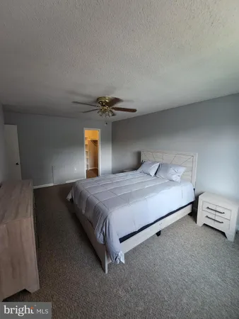 a bedroom with a bed and lamp