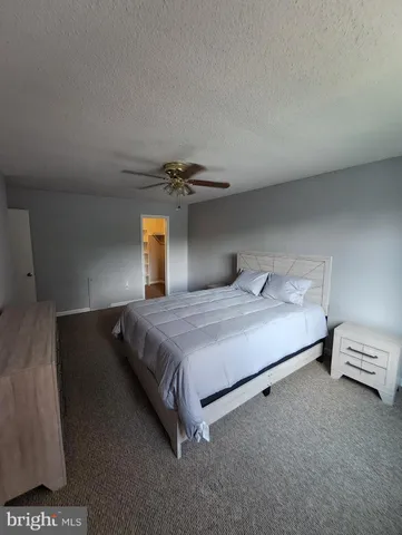 a bedroom with a bed and lamp