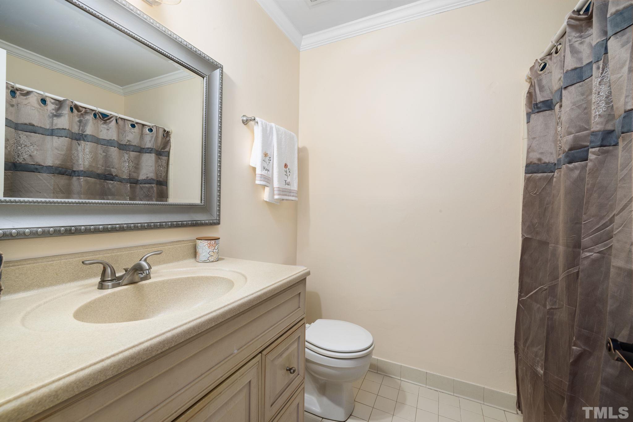 4544 Antique Lane Raleigh, NC 27616 - Photo 16 of 20 a bathroom with a sink toilet and shower
