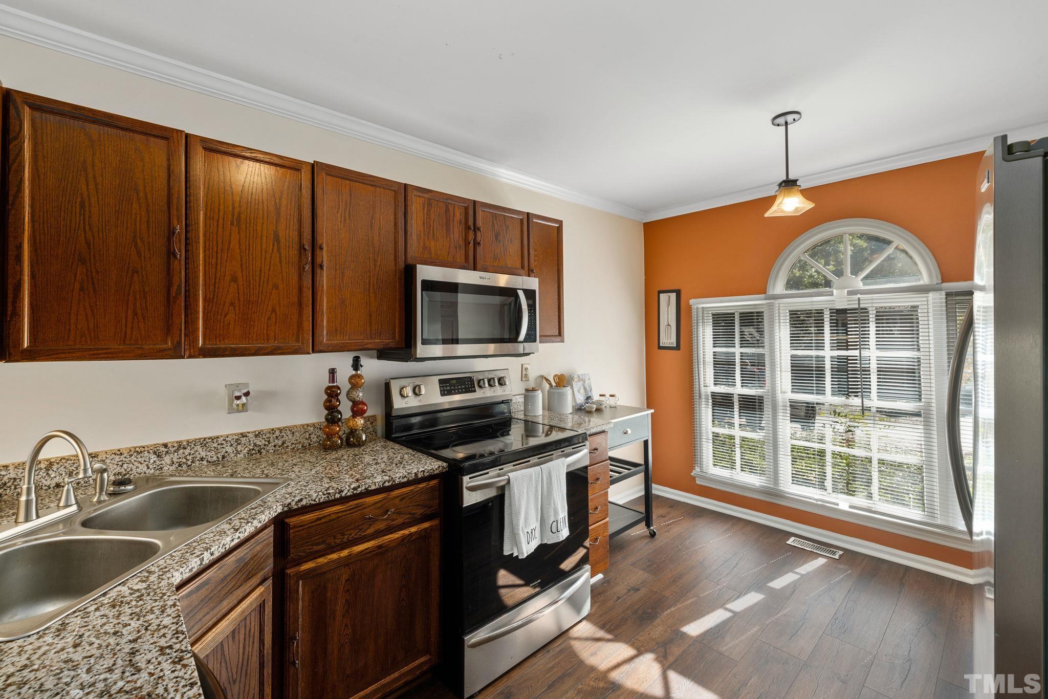 4544 Antique Lane Raleigh, NC 27616 - Photo 8 of 20 a kitchen with stainless steel appliances granite countertop a sink stove and cabinets
