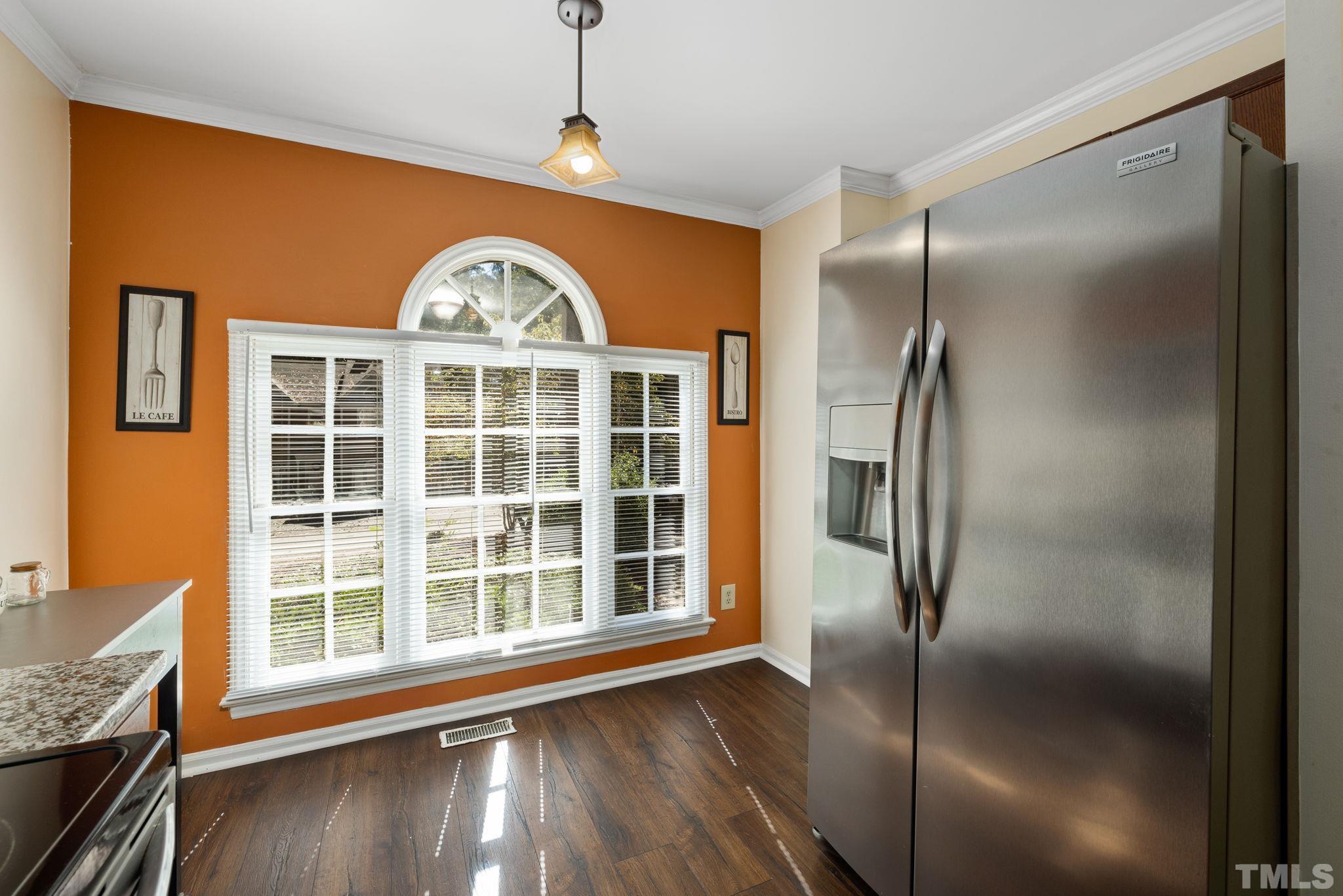 4544 Antique Lane Raleigh, NC 27616 - Photo 9 of 20 a view of a kitchen with a refrigerator and wooden floor