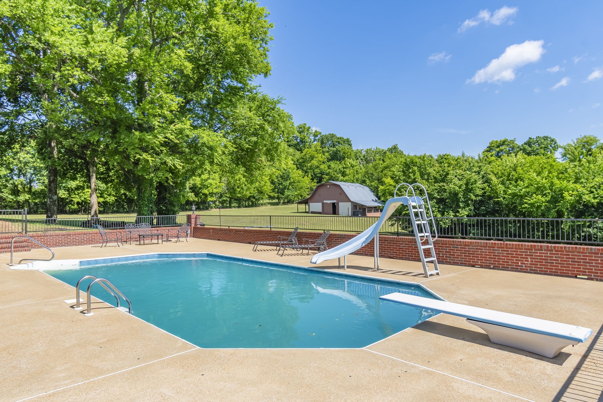 1979 Buck Daniels Road Culleoka, TN 38451 - Photo 13 of 61 a view of a swimming pool with a yard and large trees