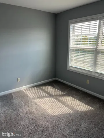 a view of an empty room and a window