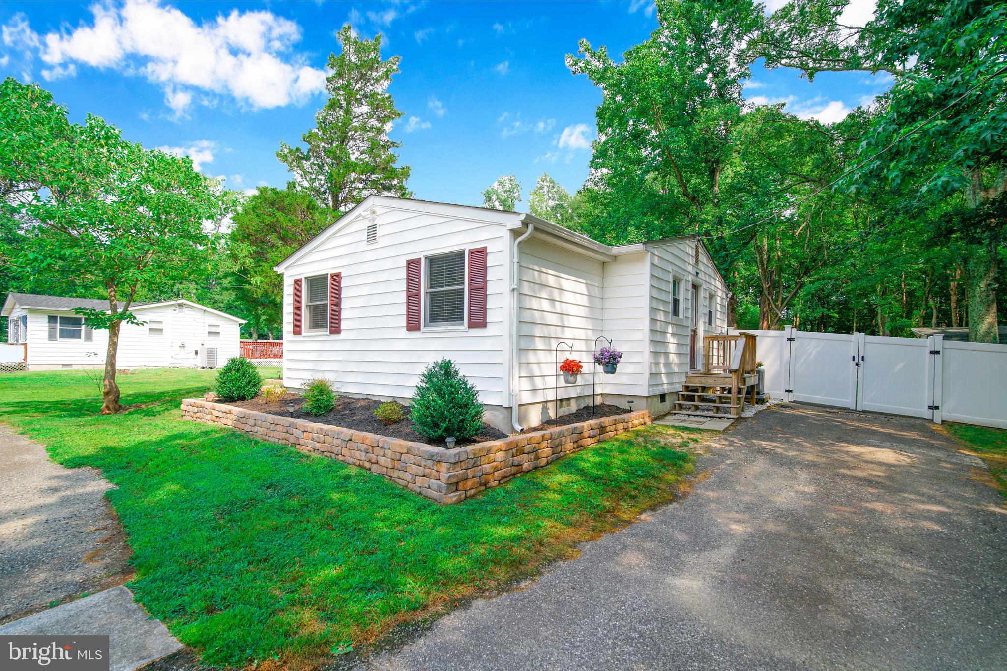 245 Newtown Road Solomons, MD 20688 - Photo 2 of 26 a front view of a house with a yard and porch