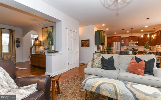 a living room with furniture a fireplace and a large mirror