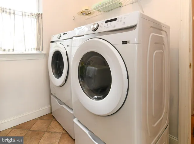 a living room with furniture and stairs