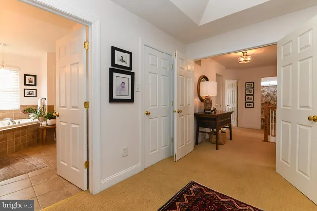 a spacious bedroom with a bed and wooden floor