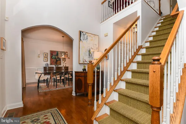 a view of entryway and hall with wooden floor